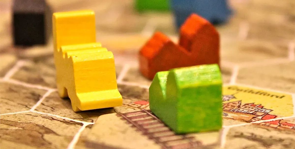 Several wooden playing pieces are laid on a hexagonal board